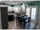 Bright kitchen features white cabinetry, stainless steel appliances, and an island with bar seating at 9612 Indian Beech Nw Ave # 1266, Concord, NC 28027