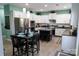 Modern kitchen with white cabinetry, stainless steel appliances, kitchen island and a cozy dining area at 9612 Indian Beech Nw Ave # 1266, Concord, NC 28027