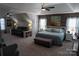 Expansive main bedroom featuring a decorative accent wall, cozy seating area, and bright natural light at 9612 Indian Beech Nw Ave # 1266, Concord, NC 28027