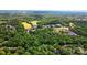 Scenic aerial view showcasing a neighborhood nestled among lush green trees and landscapes at 9927 Raddington Ln, Charlotte, NC 28269