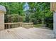 A wood deck overlooks a verdant, tree-filled backyard with a charming landscape at 9927 Raddington Ln, Charlotte, NC 28269