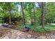 Stone path leading to a hot tub in a secluded, tree-filled backyard at 9927 Raddington Ln, Charlotte, NC 28269