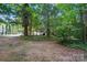 The lush backyard and driveway showing the quiet surroundings of the home at 9927 Raddington Ln, Charlotte, NC 28269
