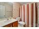 Cozy bathroom featuring a single sink vanity and shower-tub combination at 9927 Raddington Ln, Charlotte, NC 28269
