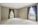 Bright bedroom with neutral walls, carpeted floors and large windows at 9927 Raddington Ln, Charlotte, NC 28269