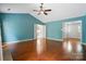 Large living room features hardwood floors, a fireplace, and views into kitchen and foyer at 9927 Raddington Ln, Charlotte, NC 28269