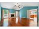 Spacious living room features hardwood floors, a fireplace, and views into kitchen and sunroom at 9927 Raddington Ln, Charlotte, NC 28269
