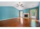 Bright living room features hardwood floors, fireplace, and french doors to deck at 9927 Raddington Ln, Charlotte, NC 28269