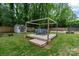 Relaxing backyard area features a wooden deck, pergola, comfy seating, storage shed, and spacious green lawn at 1014 Vandalia Dr, Charlotte, NC 28212