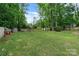 Lush, green backyard featuring a shed, patio, and mature trees providing ample shade and privacy at 1014 Vandalia Dr, Charlotte, NC 28212