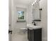 Stylish bathroom featuring a modern black vanity, white walls, and tiled floors, with an adjacent toilet at 1014 Vandalia Dr, Charlotte, NC 28212