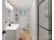Bright bathroom featuring a single sink vanity and a glass-enclosed shower with modern fixtures at 1014 Vandalia Dr, Charlotte, NC 28212