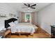 Charming bedroom with hardwood floors, white shiplap walls, and a sunlit window with patterned drapes at 1014 Vandalia Dr, Charlotte, NC 28212