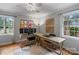 Bright home office featuring two desks, hardwood floors, a ceiling fan, and light gray walls at 1014 Vandalia Dr, Charlotte, NC 28212