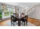 Open dining room with hardwood floors, a view of the staircase, and natural light at 1014 Vandalia Dr, Charlotte, NC 28212