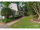 Well-maintained home with a lush lawn, mature trees, and manicured landscaping at 1014 Vandalia Dr, Charlotte, NC 28212
