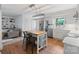Open concept kitchen with stainless appliances, white cabinets, island and view into a living space at 1014 Vandalia Dr, Charlotte, NC 28212