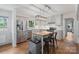 Bright kitchen with stainless steel appliances, white cabinets, and a central island with bar stool seating at 1014 Vandalia Dr, Charlotte, NC 28212