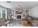 Inviting living room with fireplace, built-in shelving, hardwood floors, and ample light at 1014 Vandalia Dr, Charlotte, NC 28212