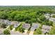 This is an aerial view of three residences with beautiful lawns and mature trees, showcasing neighborhood charm at 10418 Cullen Ct, Charlotte, NC 28278