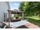 Relaxing backyard featuring a spacious wooden deck, a comfortable hammock, and a shaded gazebo with outdoor furniture at 10418 Cullen Ct, Charlotte, NC 28278