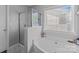 Bright bathroom features separate shower and bathtub at 10418 Cullen Ct, Charlotte, NC 28278