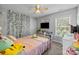 Bedroom featuring decorative vine wall, desk, and ceiling fan at 10418 Cullen Ct, Charlotte, NC 28278