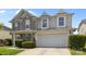 Charming two-story home featuring a two-car garage, stone accents, and manicured landscaping at 10418 Cullen Ct, Charlotte, NC 28278