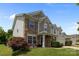Charming two-story home with a mix of stone and siding, a well-manicured lawn, and a cozy front porch at 10418 Cullen Ct, Charlotte, NC 28278