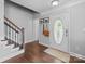 Welcoming foyer with hardwood floors, staircase, and a decorative front door at 10418 Cullen Ct, Charlotte, NC 28278