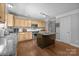 Spacious kitchen features stainless steel appliances, hardwood floors, an island, and plenty of cabinet space at 10418 Cullen Ct, Charlotte, NC 28278