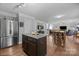 Open-concept kitchen includes island with granite countertop and is connected to a living and dining area at 10418 Cullen Ct, Charlotte, NC 28278