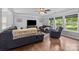 Spacious living room with hardwood floors and comfortable seating with views of the lush backyard at 10418 Cullen Ct, Charlotte, NC 28278
