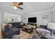 Comfortable living room with large TV, ceiling fan, lots of natural light, and access to other rooms at 10418 Cullen Ct, Charlotte, NC 28278