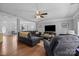 Well-lit living room with hardwood floors features comfortable seating, large windows, and an open floor plan at 10418 Cullen Ct, Charlotte, NC 28278