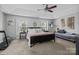 Bright main bedroom features a bed, windows, and a cozy sitting area at 10418 Cullen Ct, Charlotte, NC 28278