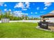 Large grassy backyard featuring outdoor grill and shed at 115 Crownpiece St, Troutman, NC 28166