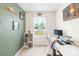 Comfortable bedroom providing ample natural light with workspace and a view of the backyard at 115 Crownpiece St, Troutman, NC 28166