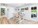 Bright dining area with views to outside, breakfast bar, and access to outdoor patio at 115 Crownpiece St, Troutman, NC 28166