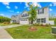 Manicured lawn and landscaping in front of a gray two story house at 115 Crownpiece St, Troutman, NC 28166
