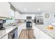 Updated kitchen featuring granite countertops, stainless appliances, and a convenient island with seating at 115 Crownpiece St, Troutman, NC 28166