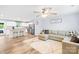 Open-concept living room and kitchen with hardwood floors, stainless appliances, and modern decor at 115 Crownpiece St, Troutman, NC 28166