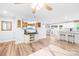 Stylish open-concept living area with hardwood floors, a breakfast bar, and modern decor at 115 Crownpiece St, Troutman, NC 28166