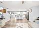 Bright, open living space with hardwood floors, a breakfast bar, and stainless steel appliances at 115 Crownpiece St, Troutman, NC 28166
