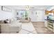 Cozy living room featuring a sectional sofa, hardwood floors, and a modern entertainment center at 115 Crownpiece St, Troutman, NC 28166