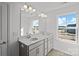 Bathroom featuring double sinks, stylish fixtures, and a bright window at 14028 Parkside Crossing Dr # 331, Charlotte, NC 28273
