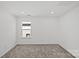 A bedroom with carpet floors, a window, and light neutral walls at 14028 Parkside Crossing Dr # 331, Charlotte, NC 28273