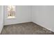 This bedroom features neutral walls, carpet flooring, and a window at 14028 Parkside Crossing Dr # 331, Charlotte, NC 28273