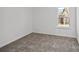 This bedroom features neutral walls, carpet flooring, and a window at 14028 Parkside Crossing Dr # 331, Charlotte, NC 28273