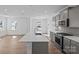Spacious kitchen with gray cabinets, a large center island, and wood floors at 14028 Parkside Crossing Dr # 331, Charlotte, NC 28273